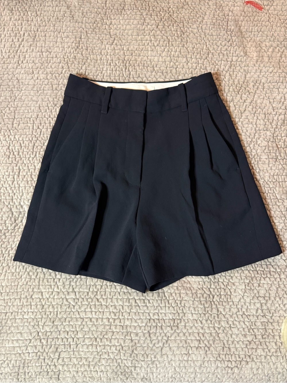 The Effortless Shorts mid-thigh length in black by Aritzia and Wilfred